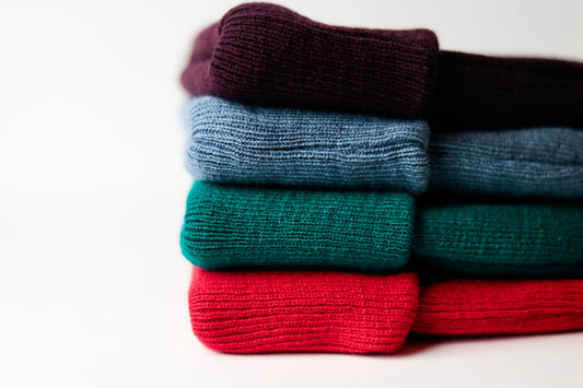 a stack of folded sweaters sitting on top of each other