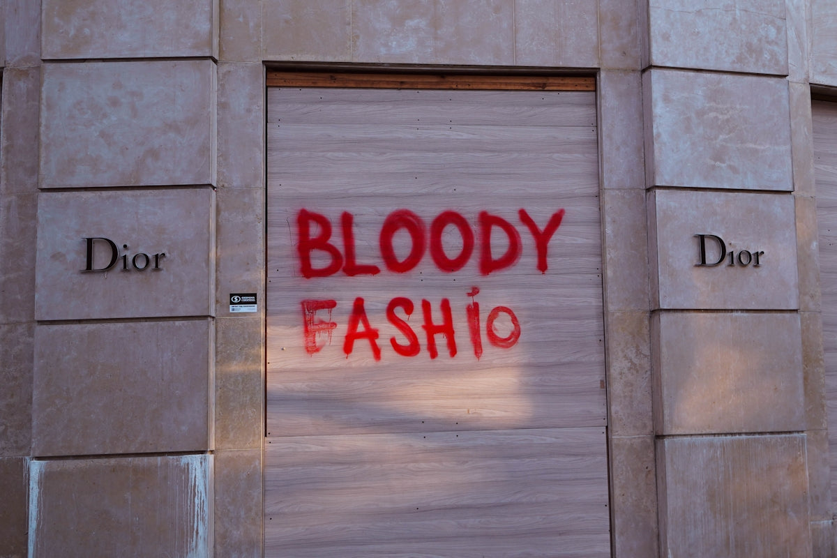 a red spray painted sign on the side of a building