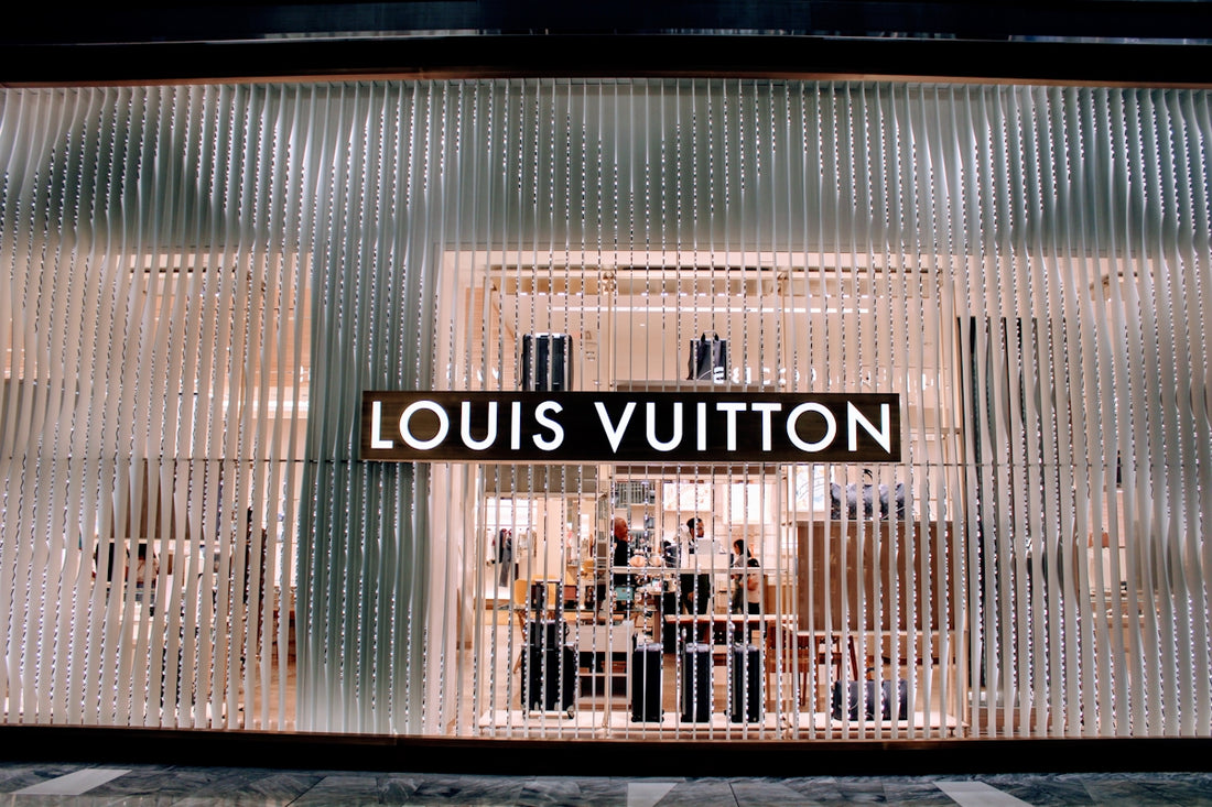 A store front with a sign that says louis vuitton