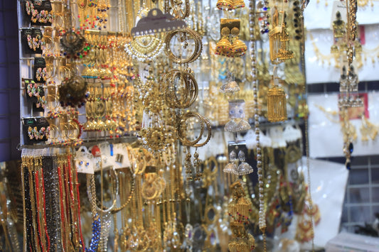 A store with lots of gold jewelry hanging from it's walls