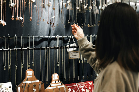 A woman looking at a display of jewelry