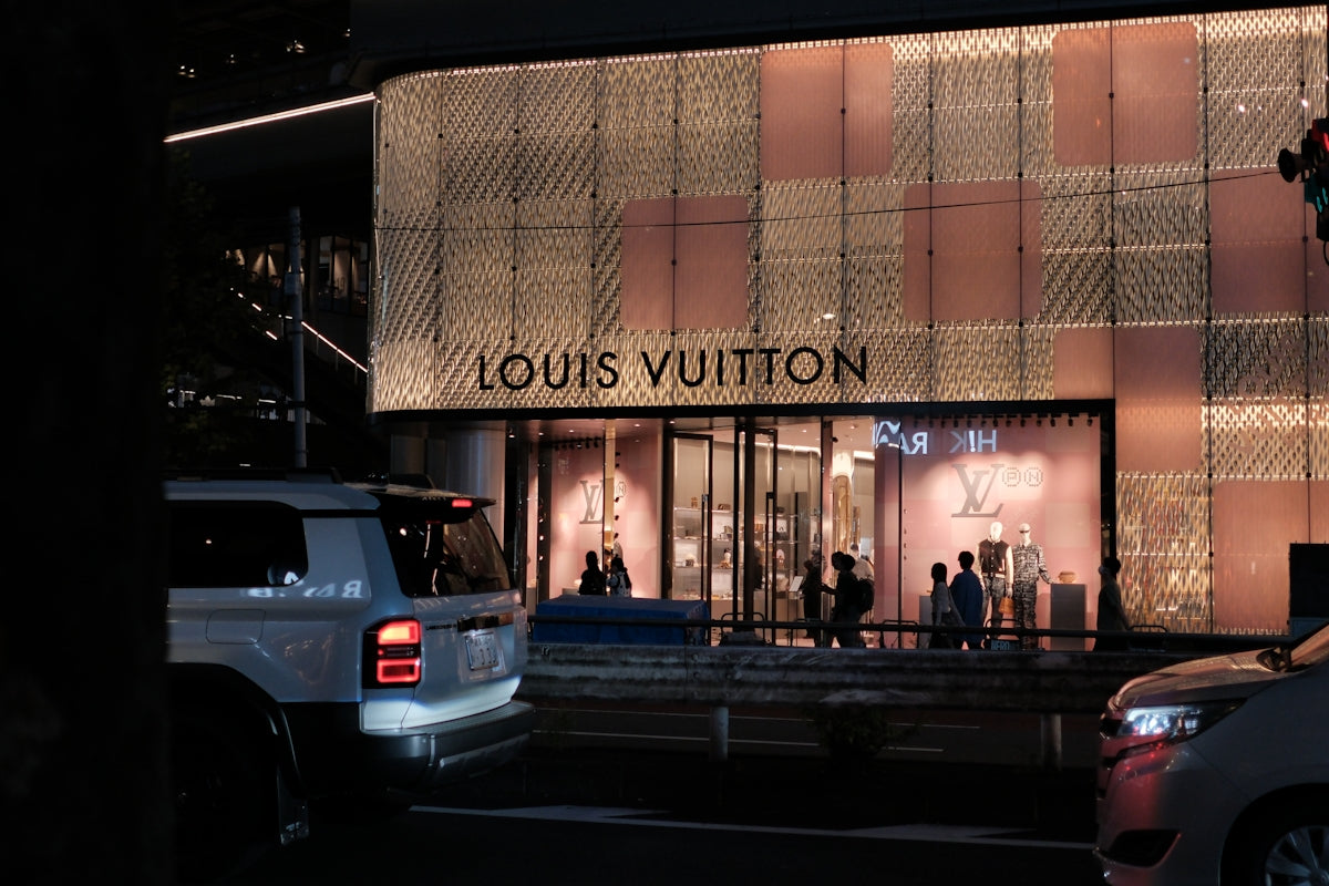 Louis vuitton store at night with cars