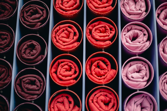 Rolled fabrics in shades of red and pink
