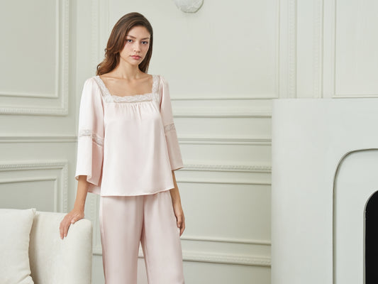 A woman in a pink silk pajama set