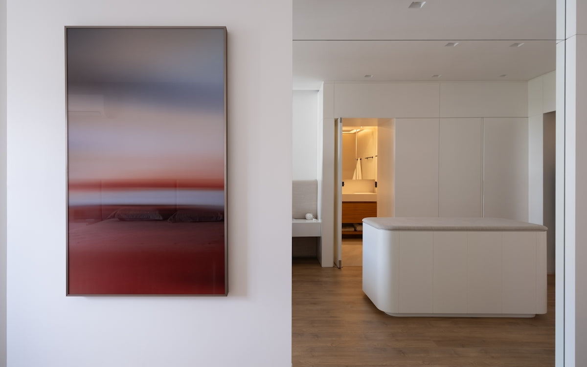 Modern abstract painting hangs in a minimalist interior.