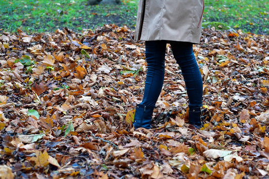 Person standing on fallen autumn leaves