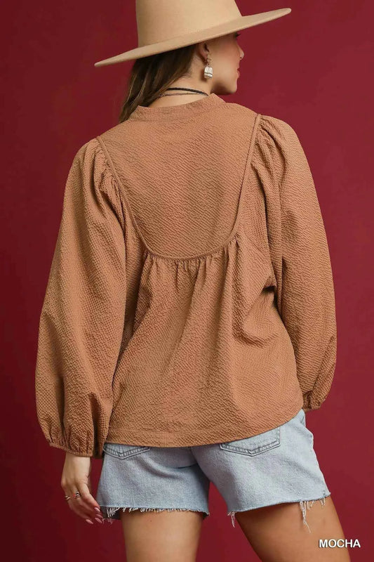 Umgee Textured Notched Blouse with Balloon Sleeves 01fc8fb0-7d74-4168-8ed6-e99b5de6a2cb-Max-Origin