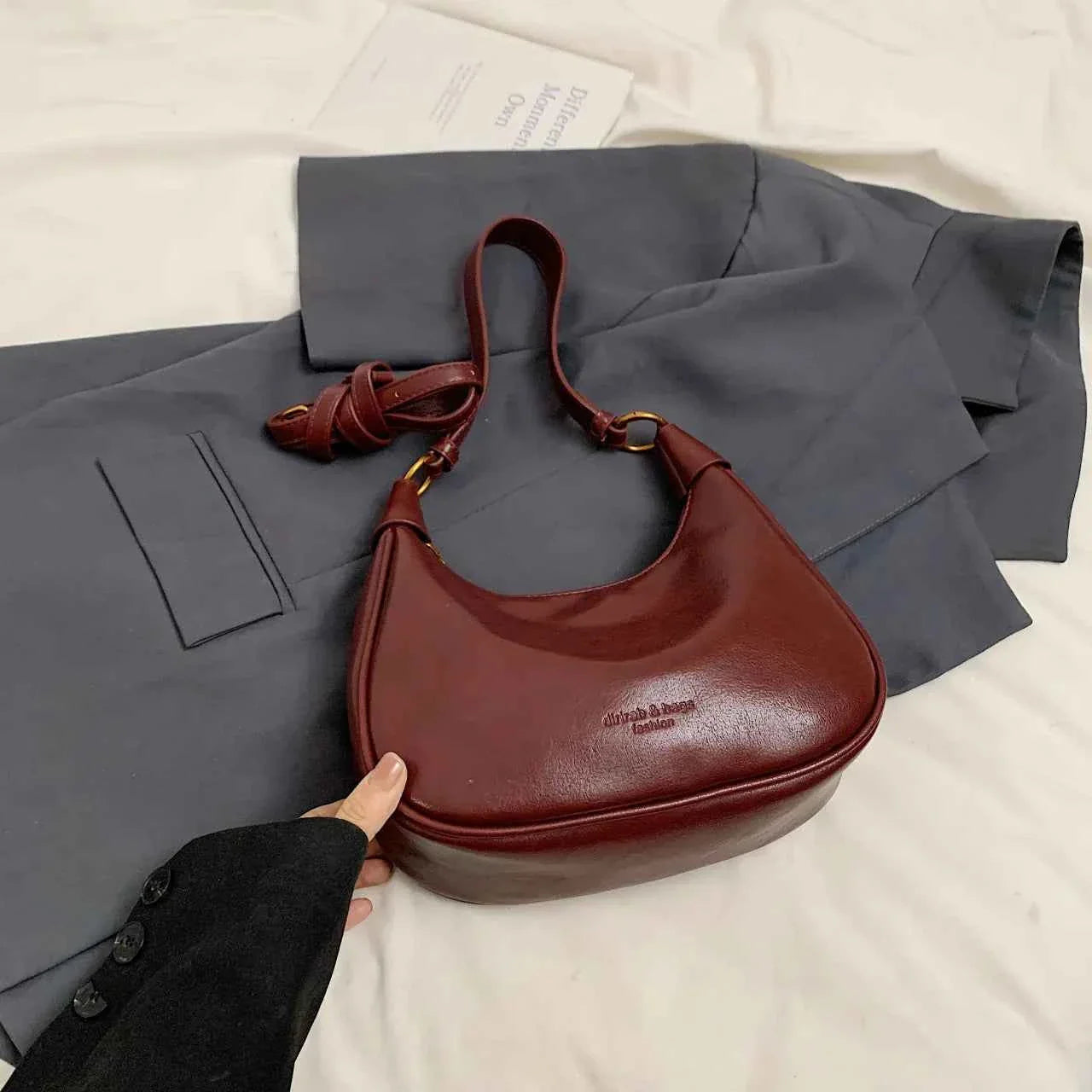Curved Leather Shoulder Bag Burgundy onesize 1a6733a123ac4014b064f07a16caa05e-Max-Origin