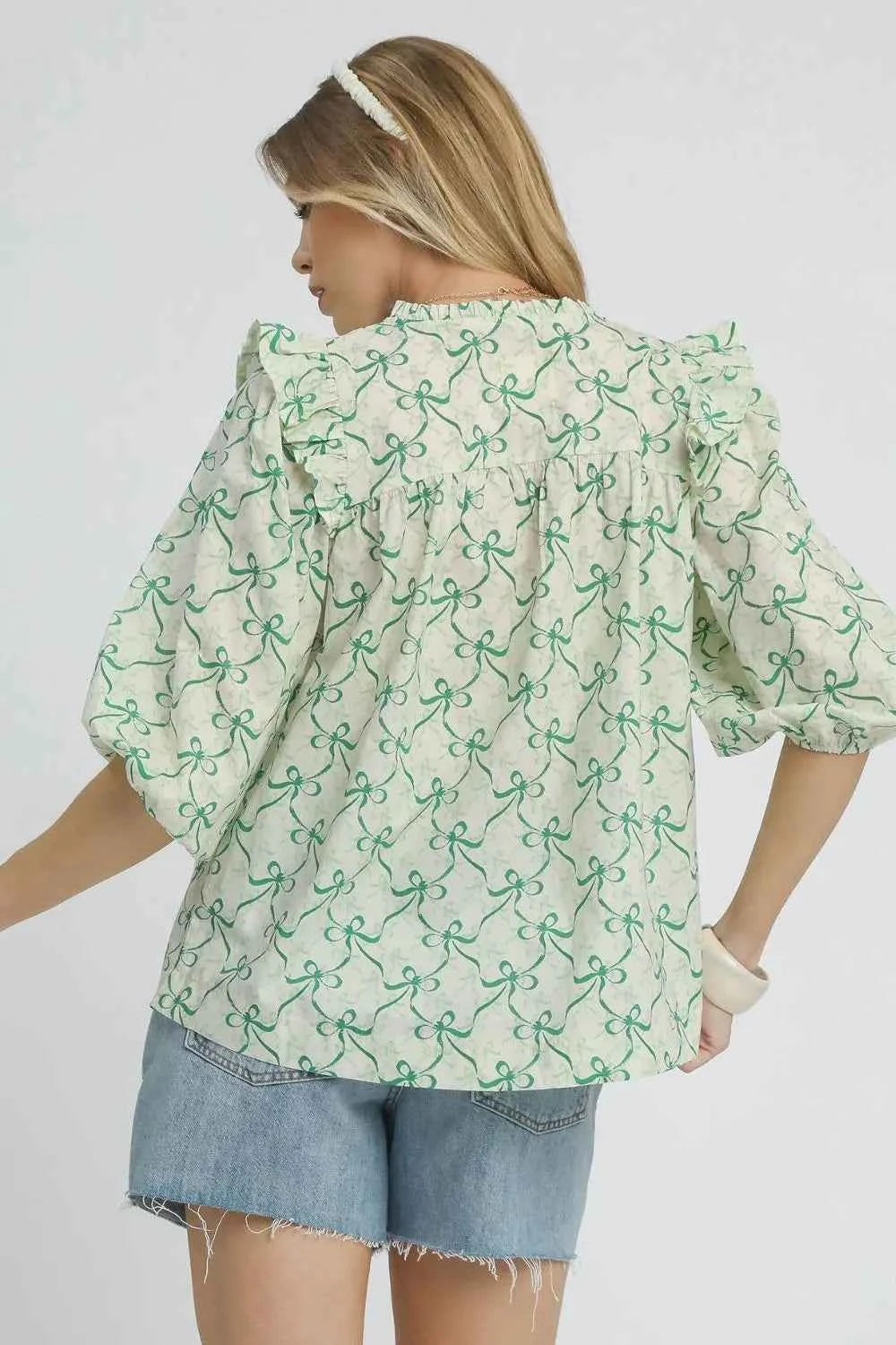 Umgee Ruffled Bow Print Notched Blouse 5dda4e59-ad5e-4bf6-8a53-41d88371b3b3-Max-Origin