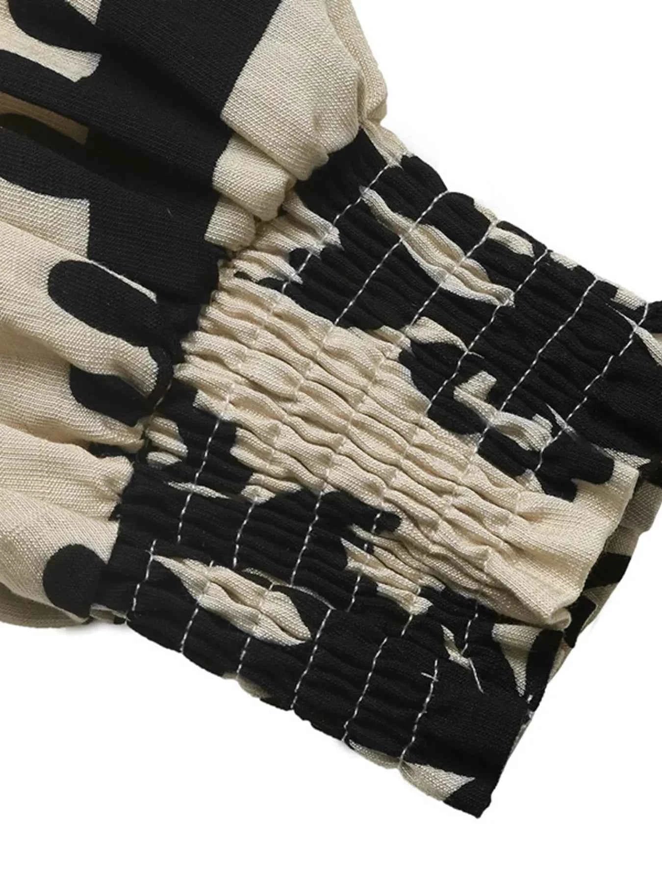 Printed Notched Lantern Sleeve Blouse 92dc6cef80b2475e90c7f51efce680de-Max-Origin